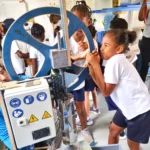 Island Academy Students turning the wheel at the WISH Workshop