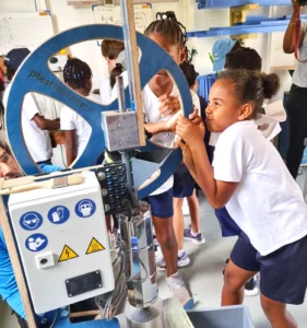 Island Academy Students turning the wheel at the WISH Workshop