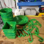 Pots, bowls and hooks made from upcycled green plastic