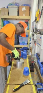 Workshop intern Keamoy closing the molds